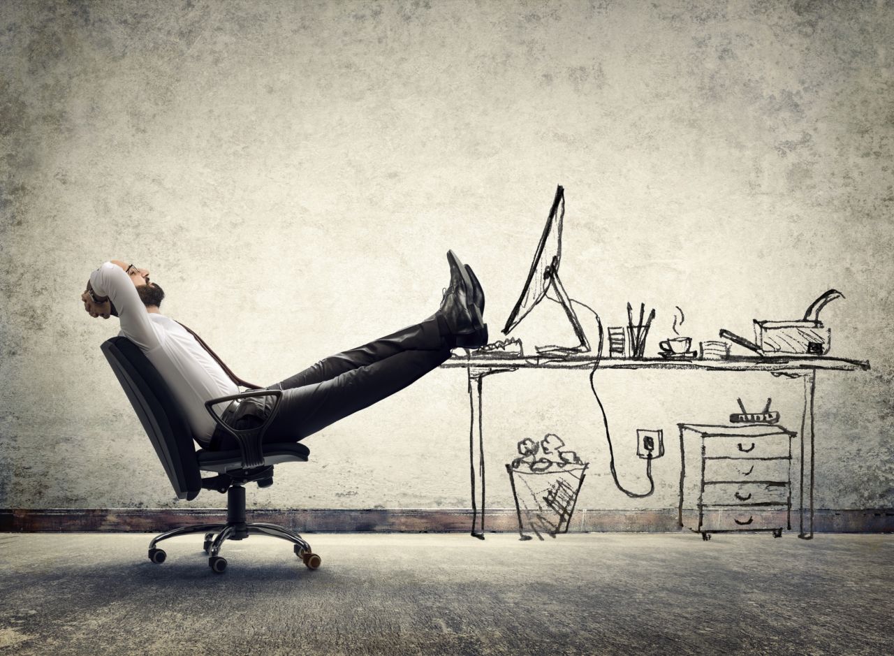 relax in office - man sitting on the drawing of desk