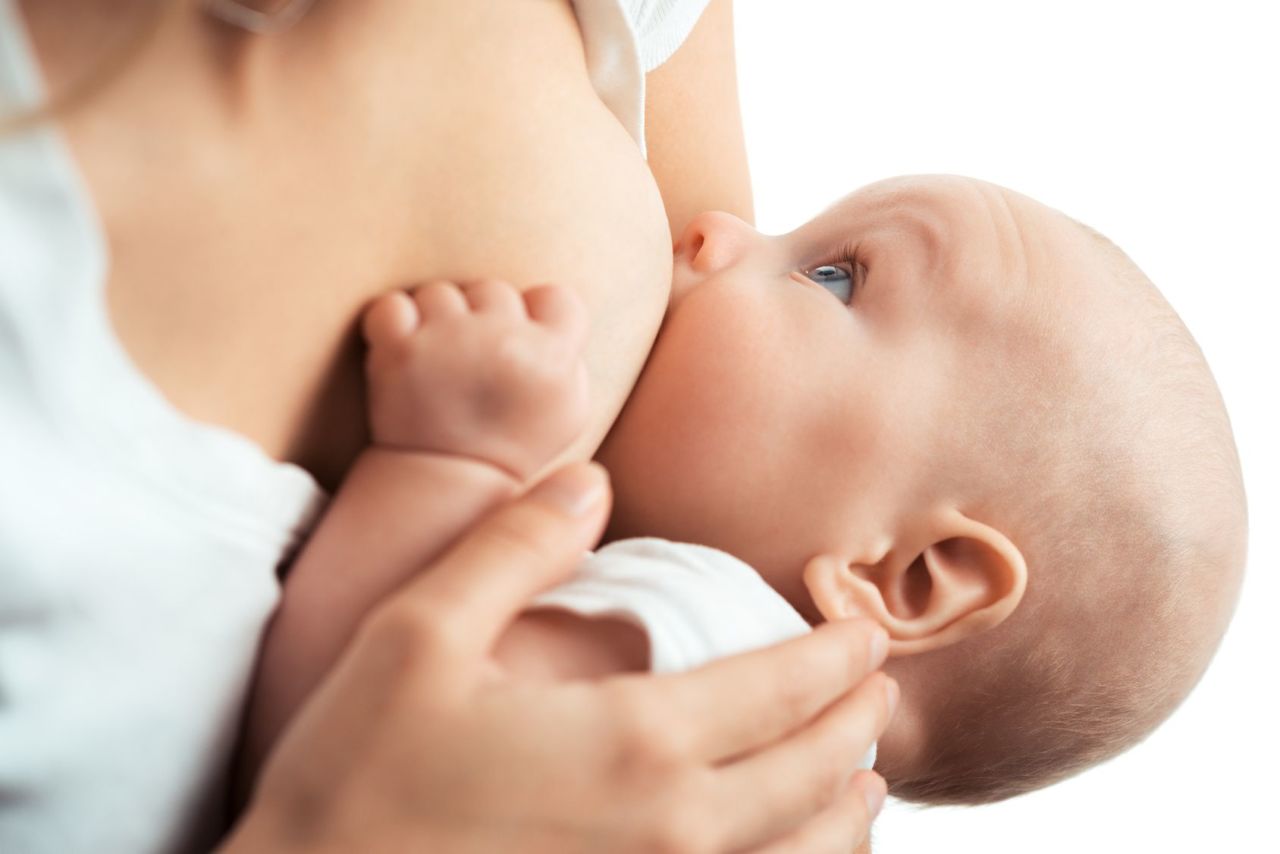 Baby feeds on MOM's breasts